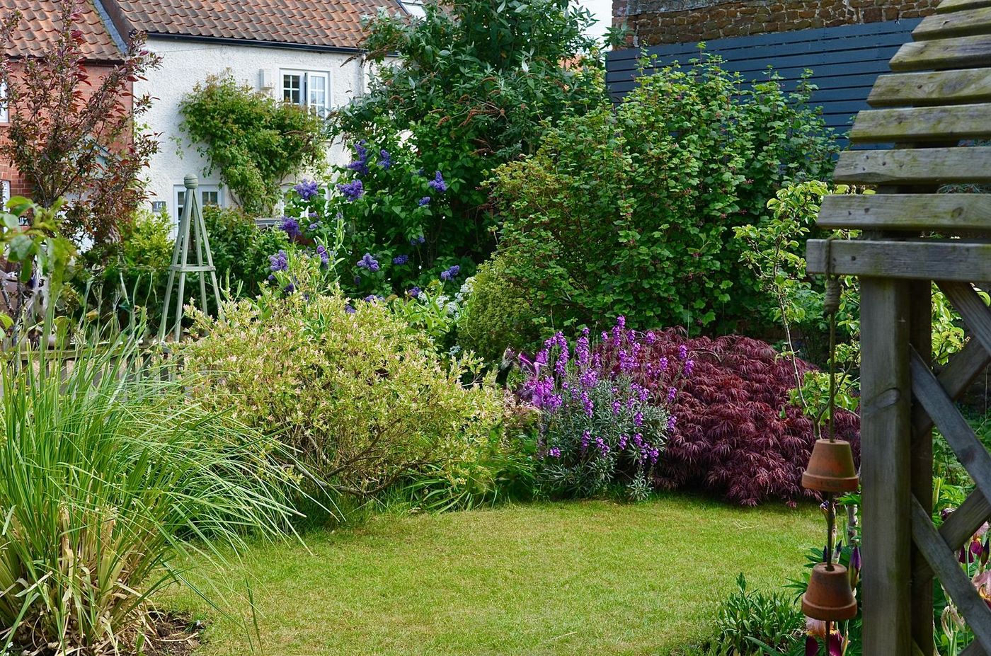Home Cottage garden border with a gravel path between perennials